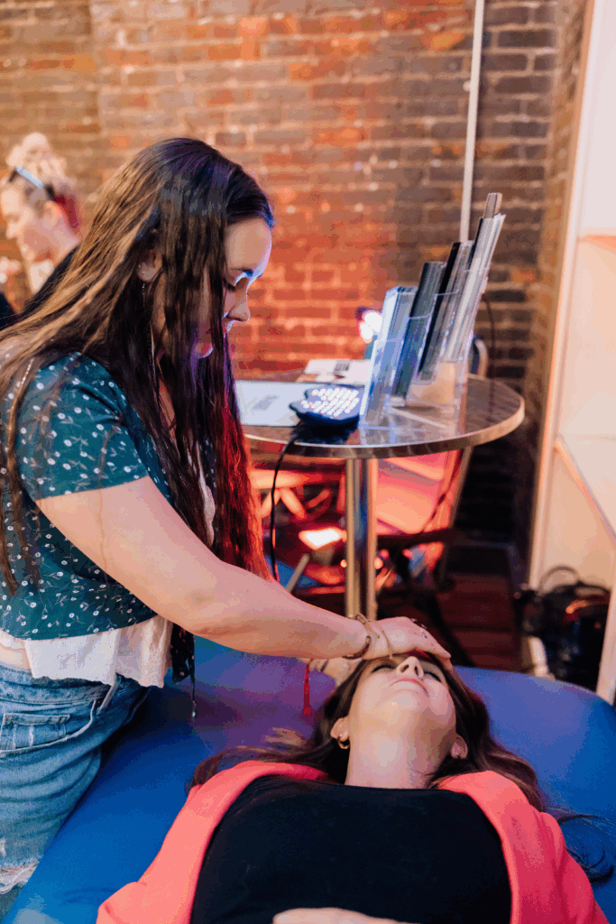 Image shows a Reiki practitioner giving Reiki to a client.