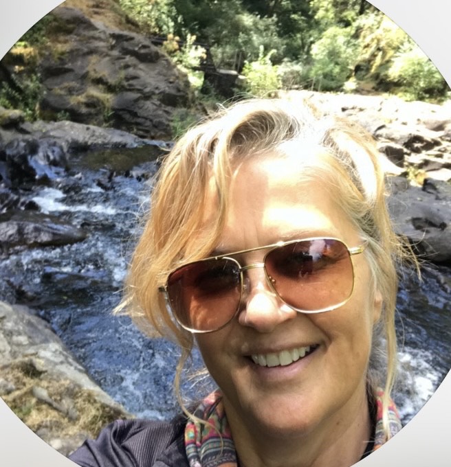 Image shows a woman smiling.